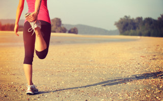 Woman running beach shadows sunset - her leg in the air free wallpaper