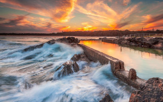 Sunset water waves rocks pier - wave free wallpaper