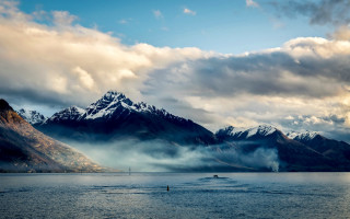 Boat mountains clouds cityscape sunset - the water in front free wallpaper