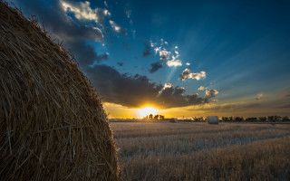 Hay bale sunset clouds cityscape - the sun setting behind free wallpaper