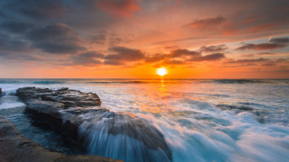Sunset ocean waves rocks person - naturalism free wallpaper