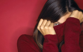 Woman in red sweater covering - a red sweater free wallpaper