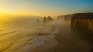 Beach cliffs foggy sky water - volumetric fog free wallpaper