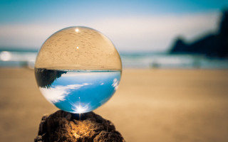 Glass ball wooden stump beach - surreal photography free wallpaper
