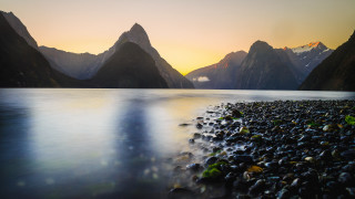 Sunset mountains lake rocks clouds - anamorphic free wallpaper