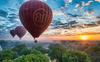 Hot air balloons sunset forest - over a forest free wallpaper