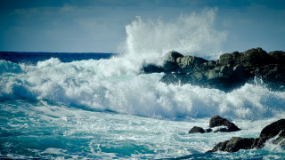 Ocean wave rock formation shore - a rock formation in the foreground free wallpaper