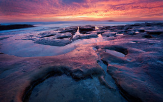 Sunset rocky beach ice water - the foreground and a body of water free wallpaper