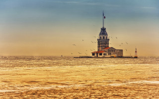 Lighthouse island ocean birds sunset - a small island in the middle of the ocean free wallpaper
