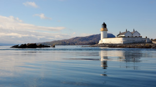 Lighthouse rocky shore mountains water - a rocky shore free wallpaper