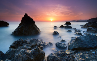 Sunset rocky beach birds bridge - a sunset over a rocky beach free wallpaper