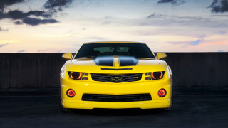 Yellow sports car sunset cloudy - a parking lot free wallpaper