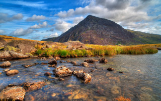 Mountain river rocks grassy landscape 2 - the water below free wallpaper