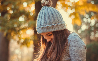 Woman hat cellphone park bokeh - a stock photo free wallpaper