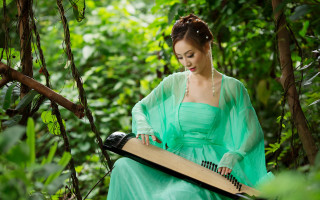Woman green dress playing music - musical free wallpaper