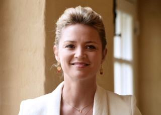 Woman white jacket smiling window - a wall in the background free wallpaper