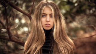 Woman longhair tree serious portrait - her face and shoulders free wallpaper