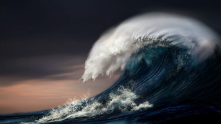 Large wave breaking ocean cloudy - a dark sky in the background free wallpaper
