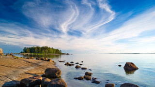Rocky shore cloudy sky mountains - akseli gallenkallela free wallpaper