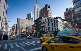 Taxi street tall buildings sky - evaline ness free wallpaper
