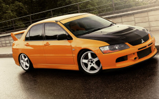 Orange car wet road fence - a wet road next free wallpaper