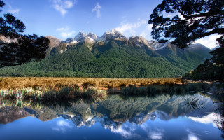 Mountain lake forest sky nature 5 - a lake in the foreground and a forest in the background free wallpaper