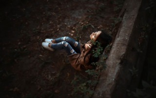 Woman lying tree trunk woods - a tree trunk free wallpaper