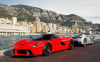 Red sports cars cityscape mountains - a city in the background free wallpaper