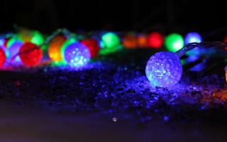Glowing lights chain macro colorful - the ground in the dark free wallpaper