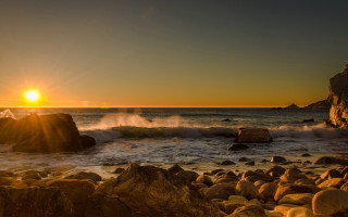 Sunset ocean rocks waves person 3 - a sunset over the ocean free wallpaper