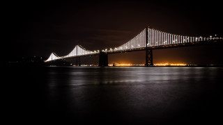 Bridge night lights city water - side and a city in the background free wallpaper