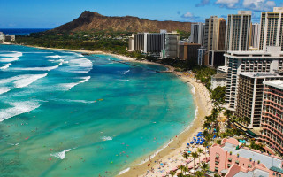 Beach crowd buildings mountain distance - building free wallpaper