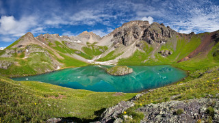 Mountain lake green grass rocks - a mountain lake free wallpaper