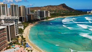 Beach people buildings mountain distance - the background and a mountain in the distance free wallpaper