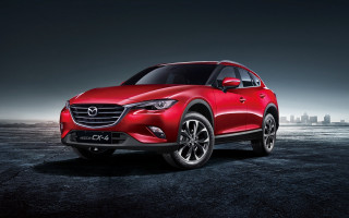 Red mazda cx3 parking lot - a city in the background free wallpaper