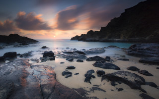 Beach rocks water sunset cloudy - rock and water under a cloudy sky free wallpaper