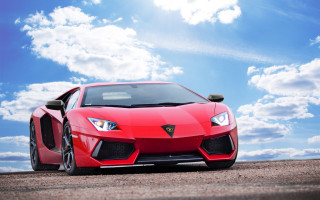 Red sports car blue sky - a red sports car free wallpaper