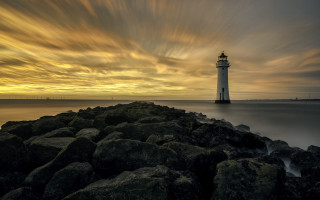 Lighthouse rocky shore cloudy sky 9 - a rocky shore free wallpaper
