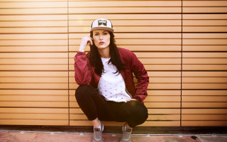 Woman ledge baseballcap redjacket blackpants - a red jacket free wallpaper