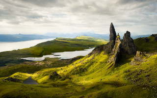 Large rock formation grassy hill - david paton free wallpaper