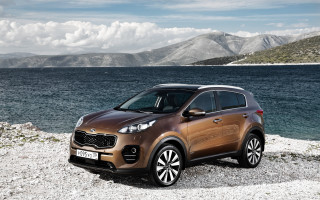 Brown car rocky shore mountains - a cloudy sky free wallpaper