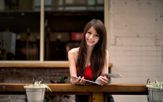 Woman table potted plant brick - a brick wall behind her free wallpaper