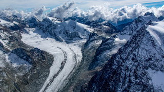 Mountain range glacier clouds plane - a view of a mountain range free wallpaper