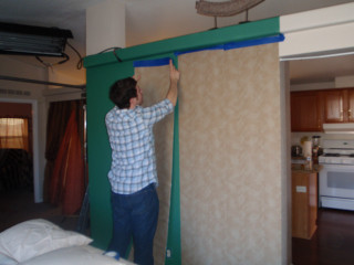 Man painting wall green frame - a wall in a room free wallpaper