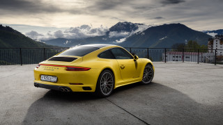 Yellow sports car mountains clouds 4 - a parking lot free wallpaper