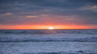 Sunset ocean wave beach city - the beach in the distance free wallpaper