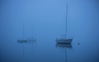 Boats foggy ocean blue sky - a blue sky behind them free wallpaper