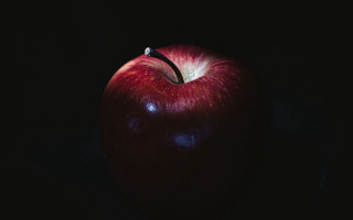 Red apple black background precisionism - a red apple free wallpaper