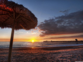 Beach sunset palm trees umbrellas - a beach free wallpaper for desktop