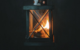 Small stove lit candle dark - inside free wallpaper